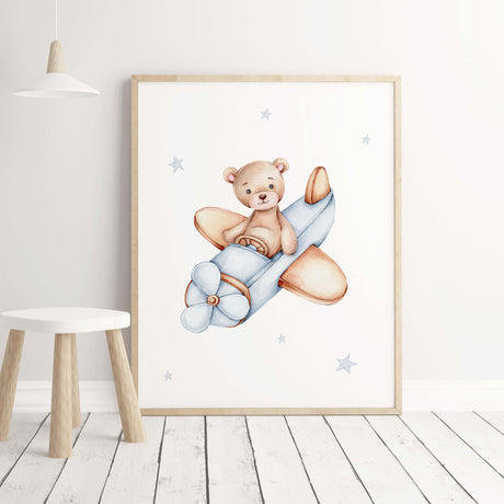 Teddy bear with airplane with light blue colors for toddler room decor.