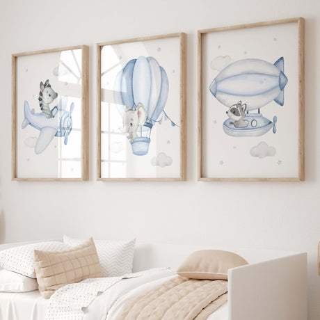 Set of 3 flying animals with zebra, elephant, raccoon, hot air balloon, airplane, airship print for toddler and boys room decor in light blue gray colors.