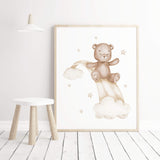 Watercolor teddy bear 
on a rainbow in beige and brown colors for gender neutral nursery ideas.